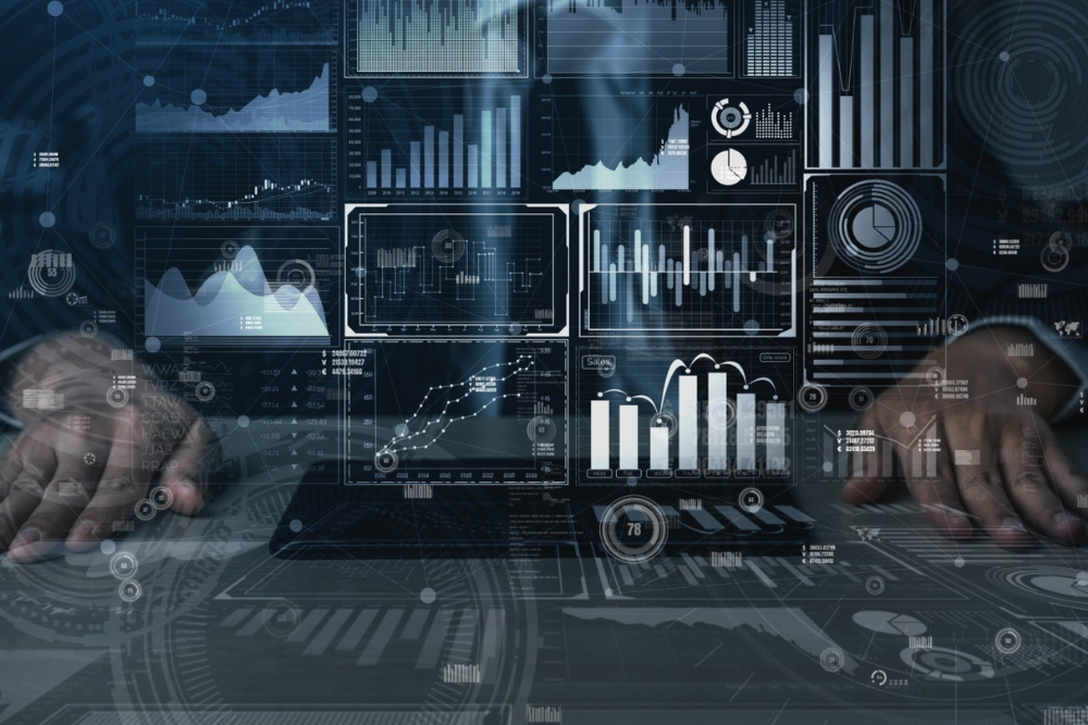 A person analyzing digital data dashboards with charts, graphs, and analytics visualizations representing Artificial Intelligence, Machine Learning, and Big Data concepts.